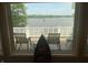 Enjoy picturesque lake views from a window showcasing a tranquil outdoor seating area and a unique boat-themed decorative piece at 3154 Beach Blvd, Cicero, IN 46034
