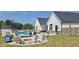 The backyard features a refreshing pool, a cozy fire pit, and ample seating at 320 Briar Hill Dr, Whiteland, IN 46184