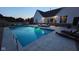 Evening shot of the backyard featuring a well-lit pool and comfortable seating area at 320 Briar Hill Dr, Whiteland, IN 46184