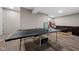 Finished basement with ping pong table, hardwood floors and comfortable seating area at 320 Briar Hill Dr, Whiteland, IN 46184