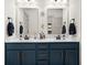 Stylish bathroom features double vanity with marble countertop and decorative mirror at 320 Briar Hill Dr, Whiteland, IN 46184