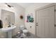 Bathroom featuring tiled floors, a pedestal sink, and a decorative sun accent at 320 Briar Hill Dr, Whiteland, IN 46184