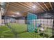 Indoor batting cage with artificial turf flooring and netting at 320 Briar Hill Dr, Whiteland, IN 46184
