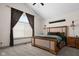 Spacious bedroom with a vaulted ceiling, a large window, and rustic wood furniture at 320 Briar Hill Dr, Whiteland, IN 46184