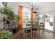 Bright dining area featuring a wooden table, indoor plants, and large windows at 320 Briar Hill Dr, Whiteland, IN 46184