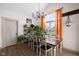 Cozy dining room featuring a wooden table with views of a window and indoor plants at 320 Briar Hill Dr, Whiteland, IN 46184
