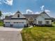 Charming home with a three car garage and a well manicured front lawn at 320 Briar Hill Dr, Whiteland, IN 46184