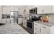Close-up of a modern kitchen with stainless steel appliances and granite countertops at 320 Briar Hill Dr, Whiteland, IN 46184