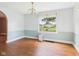 Bright dining room with hardwood floors, a classic chandelier, and ample natural light from large windows at 328 Marine Dr, Anderson, IN 46016
