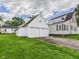 Exterior shot showcasing a detached two-car garage adjacent to the house, offering parking and storage at 328 Marine Dr, Anderson, IN 46016
