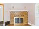 Close-up of a brick fireplace with decorative sconces and a white mantle in a living room at 328 Marine Dr, Anderson, IN 46016