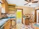Cozy kitchen with wooden cabinets, tile countertops, and a ceiling fan, offering ample storage at 328 Marine Dr, Anderson, IN 46016