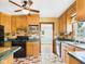 Traditional kitchen featuring wooden cabinets, tile countertops, and modern appliances at 328 Marine Dr, Anderson, IN 46016