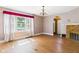 Bright living room featuring hardwood floors, a brick fireplace, and large windows with valance at 328 Marine Dr, Anderson, IN 46016