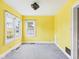 Bright yellow living room featuring large windows and neutral carpet at 328 Marine Dr, Anderson, IN 46016
