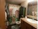 Cozy bathroom with unique shower curtain, vanity, and ample storage, offering a functional and stylish space at 3310 W State Road 58, Seymour, IN 47274