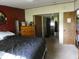 View of the bedroom showing the queen bed, bureau and doorway to hall with bathroom at 3310 W State Road 58, Seymour, IN 47274