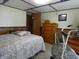 Bedroom featuring a bed, a dresser, and an exercise bike, creating a versatile living space at 3310 W State Road 58, Seymour, IN 47274