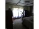 Cozy bedroom with carpet, an exercise bike, and curtains, providing a comfortable space for relaxation and fitness at 3310 W State Road 58, Seymour, IN 47274