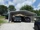 Carport with gravel base provides covered parking for multiple vehicles at 3310 W State Road 58, Seymour, IN 47274