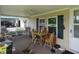 Inviting covered porch with outdoor dining area and comfortable seating space with room for friends at 3310 W State Road 58, Seymour, IN 47274