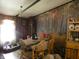 Cozy dining area featuring a wooden accent wall mural of deer in the forest and natural light and dog bed at 3310 W State Road 58, Seymour, IN 47274