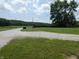 Long gravel driveway with mature landscaping leads to a private retreat at 3310 W State Road 58, Seymour, IN 47274