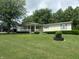 Charming single story home with a covered porch and well-maintained lawn and landscaping at 3310 W State Road 58, Seymour, IN 47274