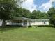 Covered front porch and manicured landscaping create curb appeal at 3310 W State Road 58, Seymour, IN 47274