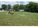 Long gravel drive with a large lawn leads to this single story home and carport at 3310 W State Road 58, Seymour, IN 47274