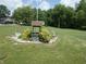 Unique garden feature and well maintained landscaping create an inviting front yard at 3310 W State Road 58, Seymour, IN 47274