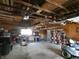 Garage interior with overhead beams, workshop area, and shelving at 3310 W State Road 58, Seymour, IN 47274