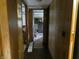 Hallway featuring wood paneling and a glimpse into a bedroom, offering a glimpse of the home's layout at 3310 W State Road 58, Seymour, IN 47274