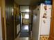 Open view from hallway to a kitchen with white refrigerator and dark cabinets, offering a functional layout at 3310 W State Road 58, Seymour, IN 47274