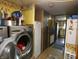 Laundry area featuring a modern washer, vintage decor, and hallway leading to the kitchen, offers practicality and charm at 3310 W State Road 58, Seymour, IN 47274