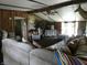 Bright living room featuring wood paneling, high ceilings, ceiling fan, and ample natural light at 3310 W State Road 58, Seymour, IN 47274