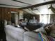 Comfortable living room featuring wood paneling, high ceilings, ceiling fan, and ample natural light at 3310 W State Road 58, Seymour, IN 47274