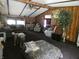 Spacious living room featuring wood paneling, high ceilings, ceiling fan, natural light and playful dog at 3310 W State Road 58, Seymour, IN 47274