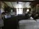 Cozy living room with wood paneling, high ceilings, ceiling fan, natural light and comfortable seating at 3310 W State Road 58, Seymour, IN 47274