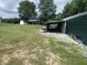 Exterior of outbuilding shows storage sheds, shelters, and green lawn at 3310 W State Road 58, Seymour, IN 47274