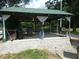 Pavilion featuring outdoor cooking area and scenic views of pond and treed landscape at 3310 W State Road 58, Seymour, IN 47274