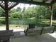Picturesque view from the covered patio, featuring a tranquil pond with a swing, ideal for relaxation and nature appreciation at 3310 W State Road 58, Seymour, IN 47274
