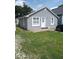 Charming single-story home with gray siding, well-maintained lawn, and inviting entrance at 3330 S Mooresville Rd, Indianapolis, IN 46221