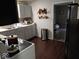 Efficient kitchen with wooden floors, appliances and access to another room at 3330 S Mooresville Rd, Indianapolis, IN 46221