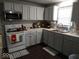 Bright kitchen with appliances, laminate countertops and wood-look flooring at 3330 S Mooresville Rd, Indianapolis, IN 46221