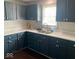 Kitchen featuring blue cabinets and white countertops at 3330 S Mooresville Rd, Indianapolis, IN 46221
