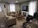 Inviting living room featuring a fireplace, neutral-toned sofas, and stylish decor at 3330 S Mooresville Rd, Indianapolis, IN 46221