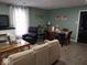 Open-concept living room with modern furnishings, including a dining table and comfortable seating at 3330 S Mooresville Rd, Indianapolis, IN 46221