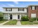 Traditional two-story townhome featuring a classic white facade, black shutters and neatly kept lawn at 3343 Ashley Ln, Indianapolis, IN 46224