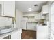 Well-equipped kitchen area featuring white appliances, ample counter space and vinyl wood-look floors at 3343 Ashley Ln, Indianapolis, IN 46224